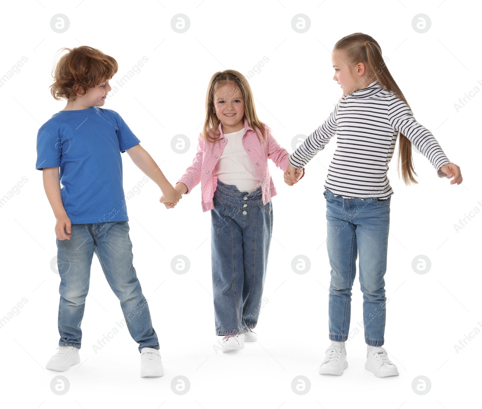 Photo of Group of cute children holding hands on white background