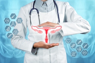 Doctor holding virtual image of uterus and different icons on light blue background, closeup