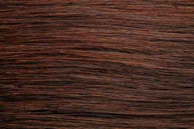 Photo of Texture of healthy brown hair as background, closeup