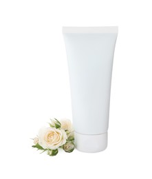 Photo of Tube of hand cream and roses on white background