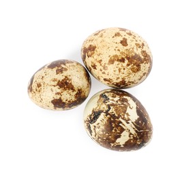 Photo of Beautiful speckled quail eggs on white background, top view