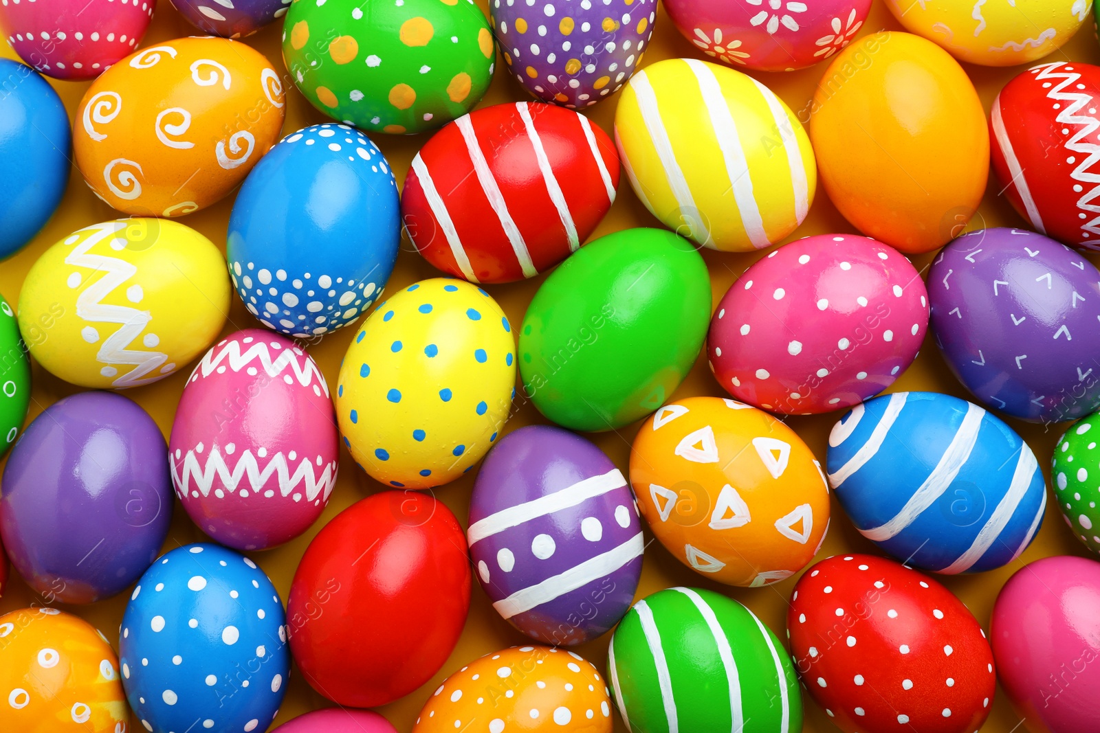 Photo of Many decorated Easter eggs as background, top view. Festive tradition