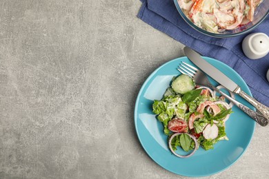 Plate of delicious vegetable salad dressed with mayonnaise served on light table, flat lay. Space for text