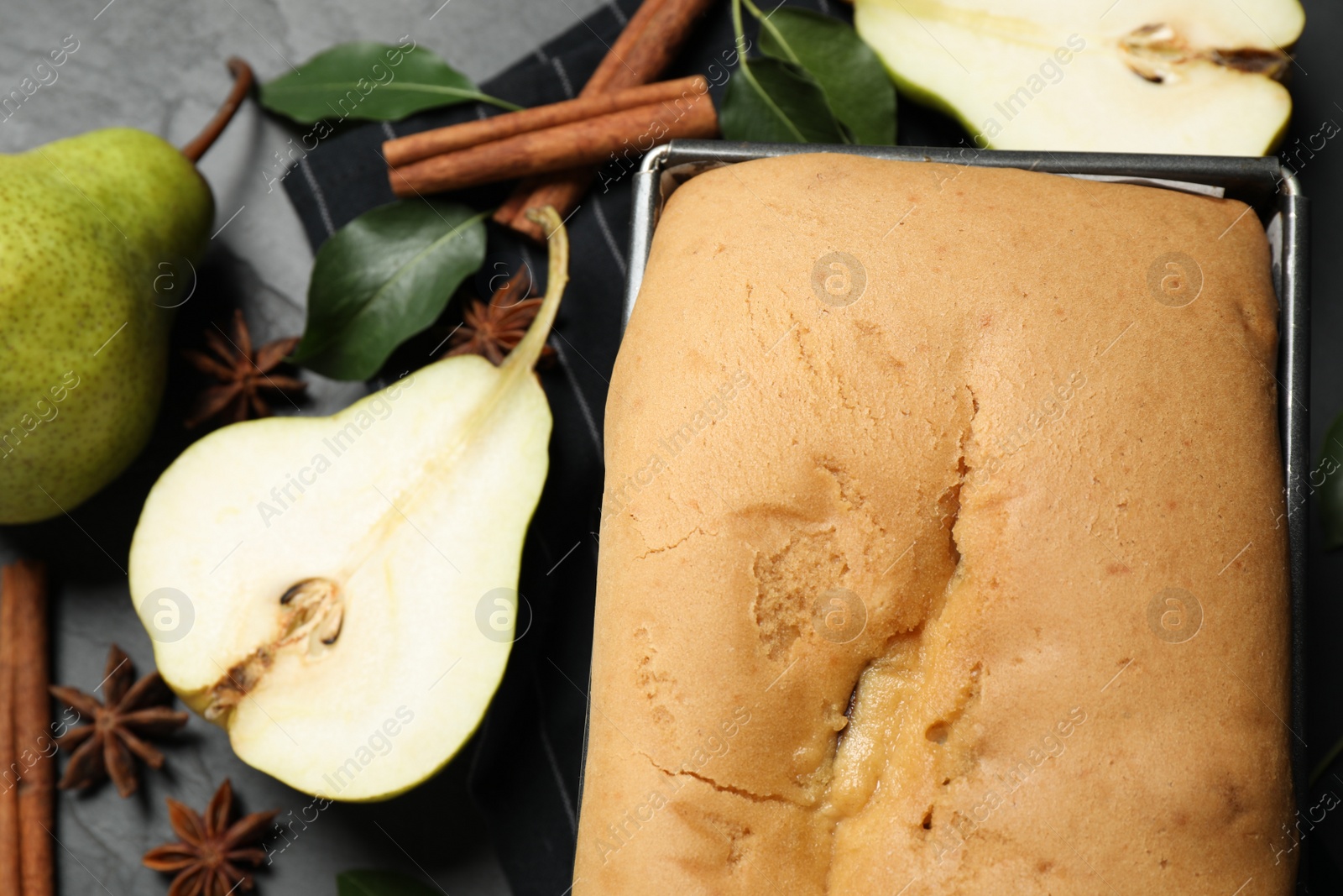 Photo of Tasty bread with pears on table, closeup. Homemade cake