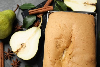 Photo of Tasty bread with pears on table, closeup. Homemade cake