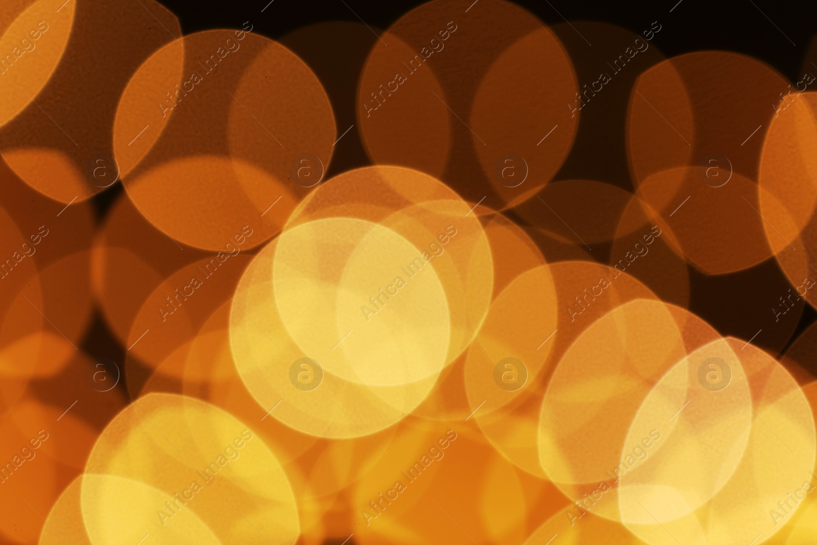 Photo of Beautiful golden lights on dark background. Bokeh effect