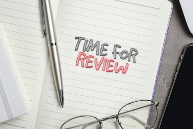 Image of Notepad with text Time For Review, pen, glasses and mobile phone on grey table, flat lay