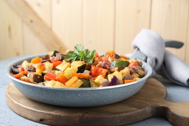 Photo of Delicious ratatouille in frying pan on table, closeup. Space for text