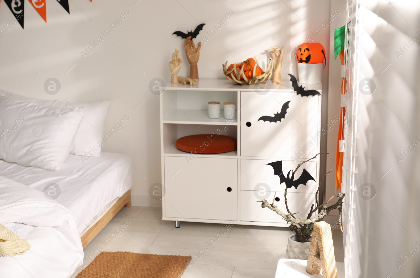 Photo of Stylish bedroom interior with festive Halloween decor