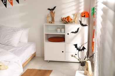 Photo of Stylish bedroom interior with festive Halloween decor