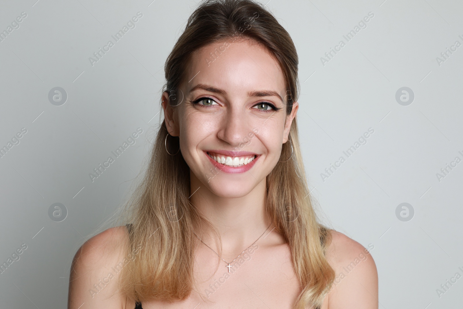 Photo of Portrait of beautiful woman on light background