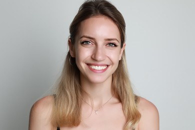 Portrait of beautiful woman on light background