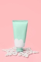 Photo of Winter skin care. Stylish presentation of hand cream on pink background
