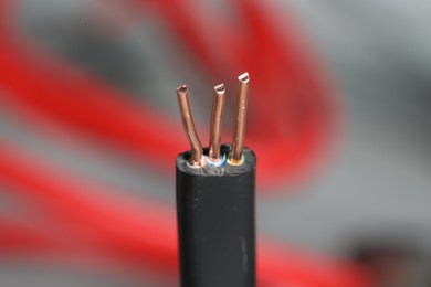 Photo of Black electrical wires on blurred background, closeup