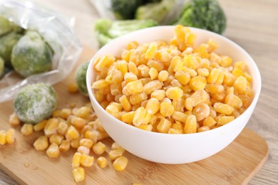 Photo of Frozen vegetables on wooden table, closeup view