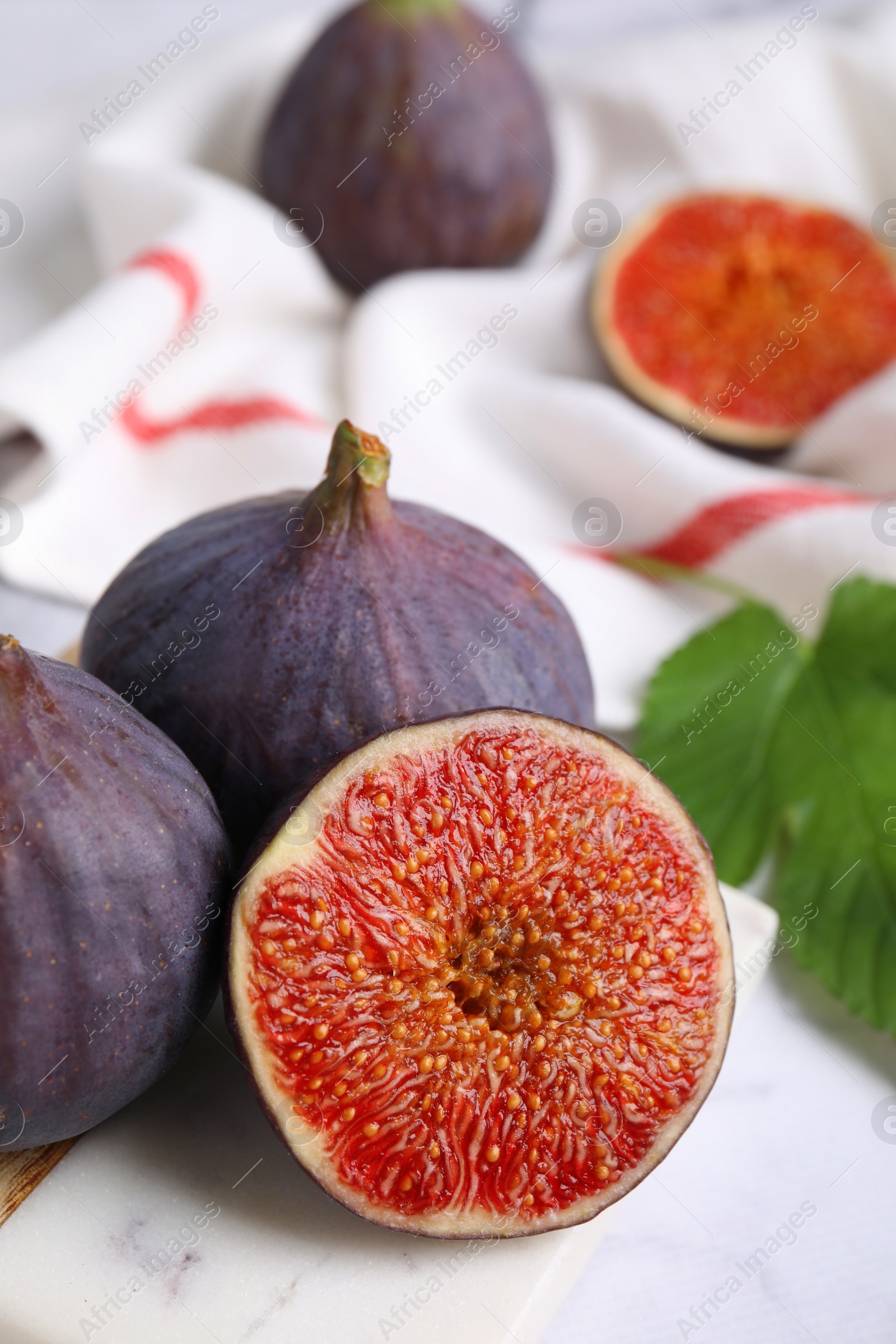 Photo of Fresh ripe purple figs on board, closeup