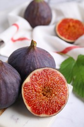 Fresh ripe purple figs on board, closeup