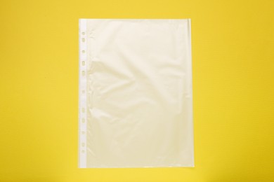 Photo of Punched pocket on yellow background, top view