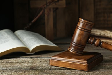 Photo of Judge gavel on old wooden table, closeup. Space for text