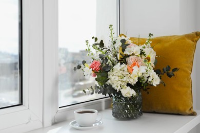 Photo of Bouquet of beautiful flowers and coffee on windowsill