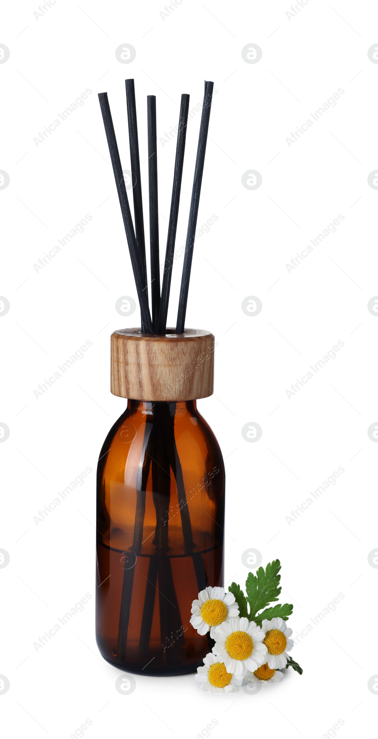 Photo of Aromatic reed air freshener and chamomiles on white background