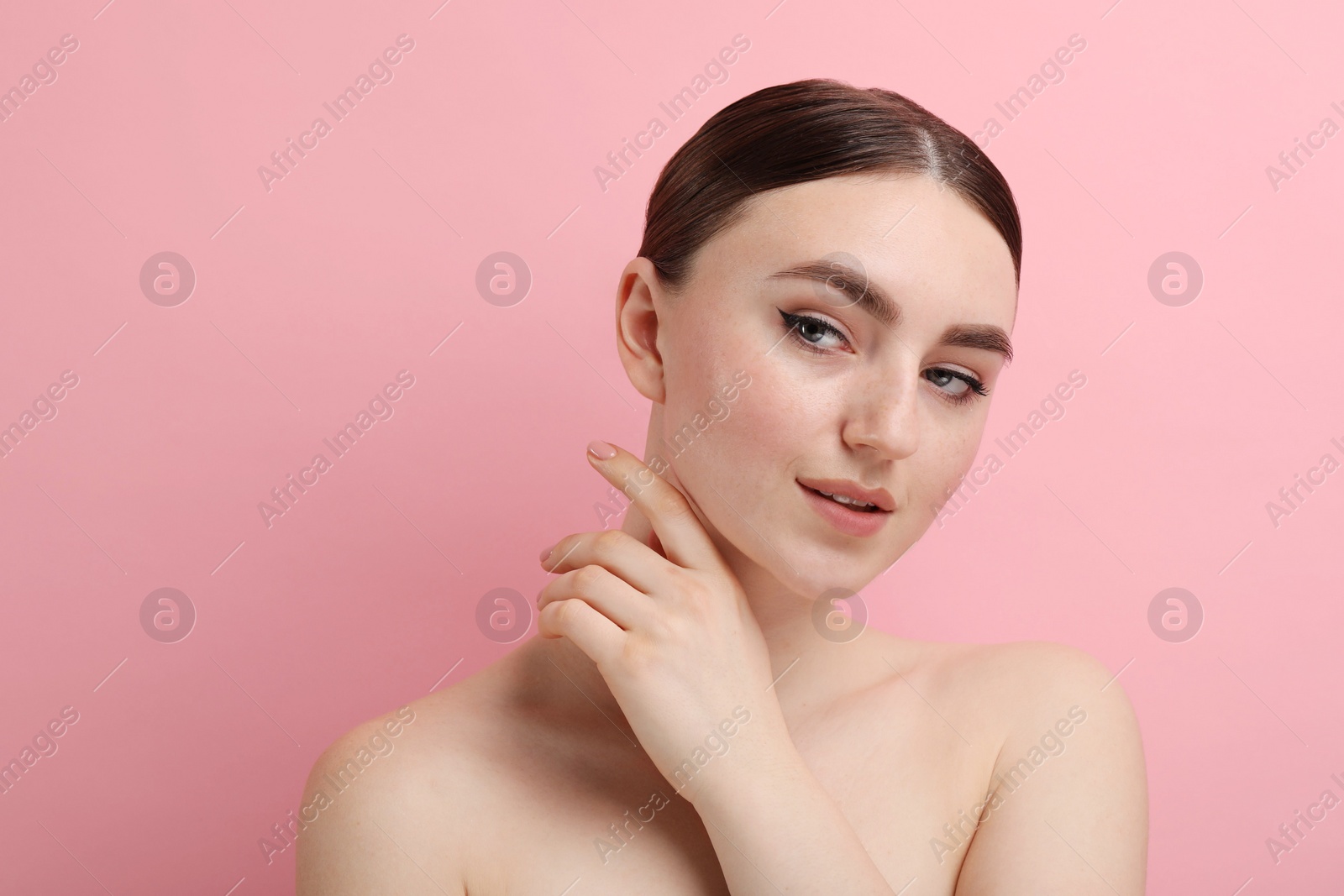 Photo of Makeup product. Woman with black eyeliner and beautiful eyebrows on pink background