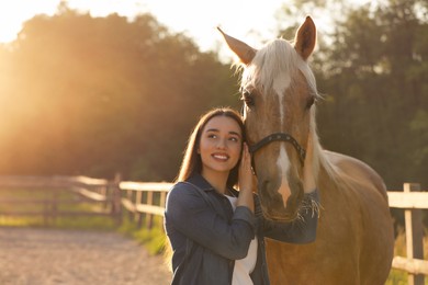 Photo of Beautiful woman with adorable horse outdoors, space for text. Lovely domesticated pet