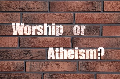 Worship Or Atheism? phrase on brick wall