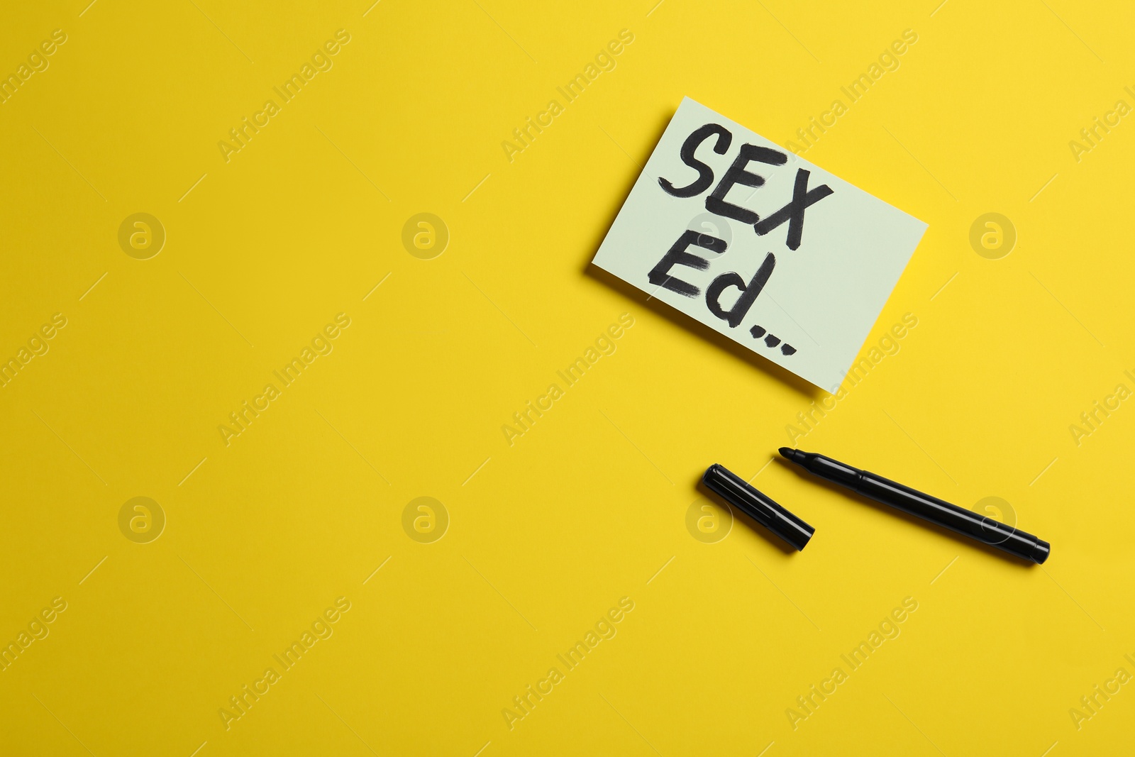 Photo of Note with text "SEX ED..." on yellow background, flat lay. Space for text