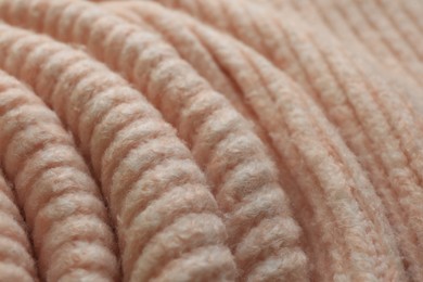 Beautiful pale pink knitted fabric as background, closeup
