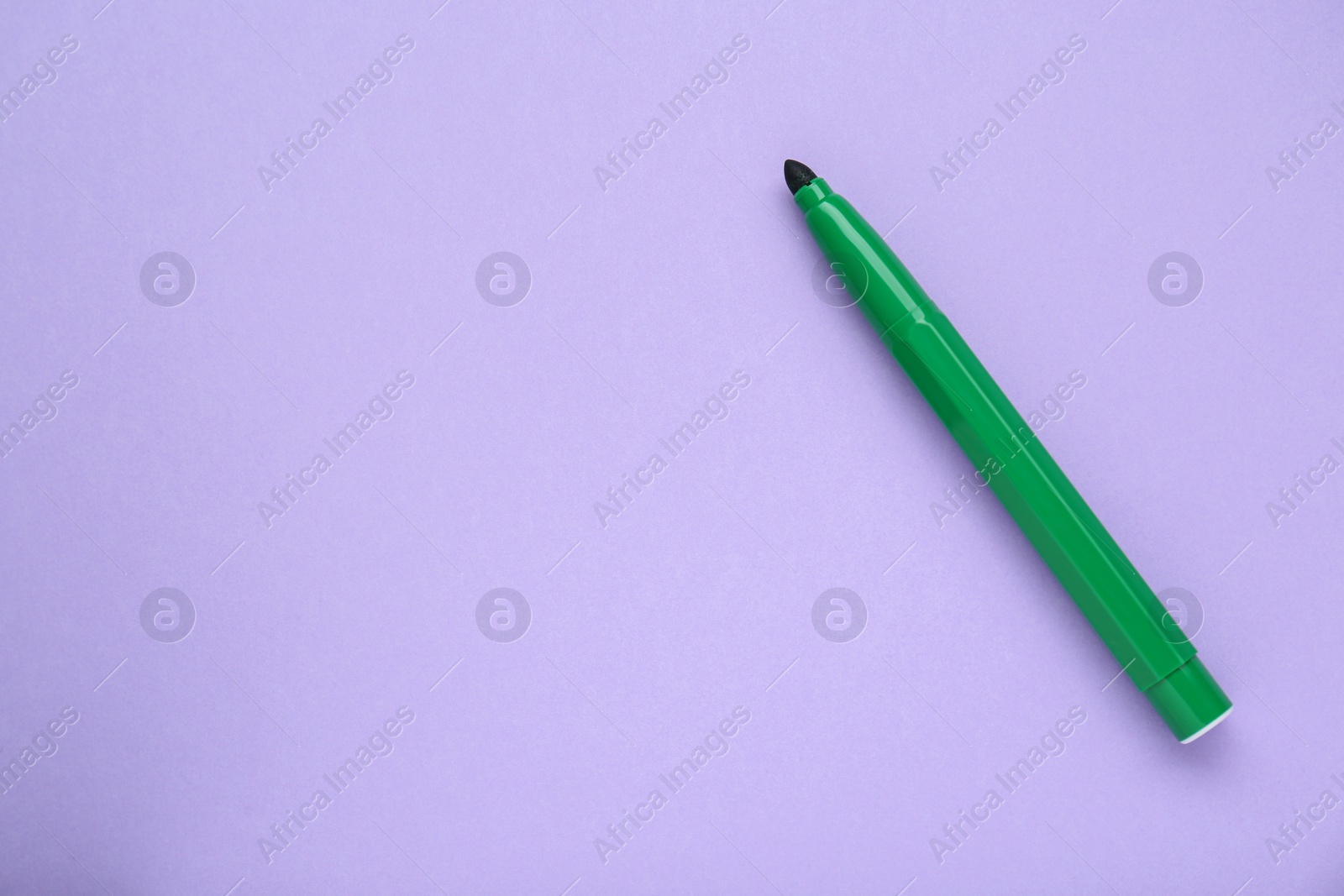 Photo of Green marker on light background, top view. Space for text