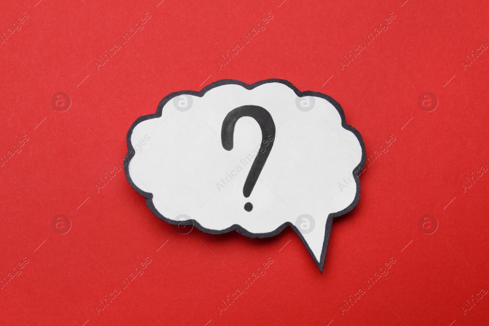 Photo of Paper speech bubble with question mark on red background, top view