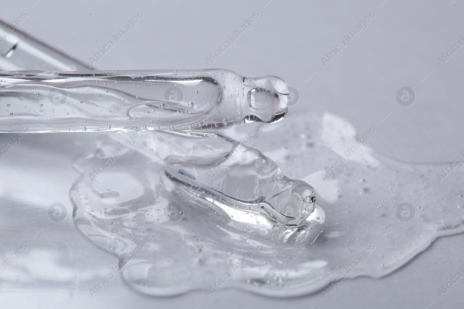 Photo of Pipettes with cosmetic serum on white background, closeup