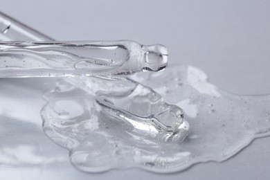 Pipettes with cosmetic serum on white background, closeup