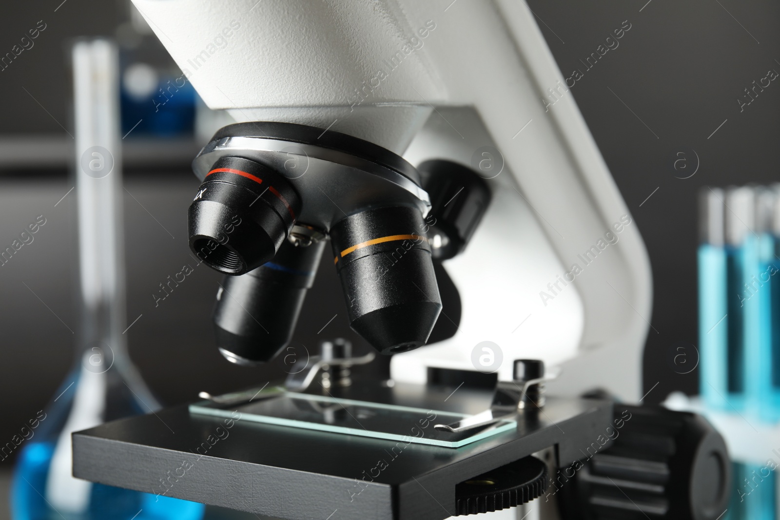 Photo of Modern microscope with different lenses in laboratory, closeup. Medical equipment