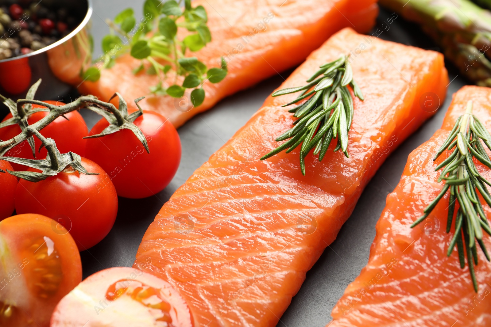 Photo of Fresh raw salmon and ingredients for marinade on grey table, closeup