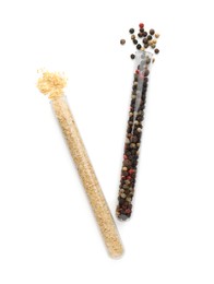 Photo of Glass tubes with garlic powder and mixed peppercorns on white background, top view