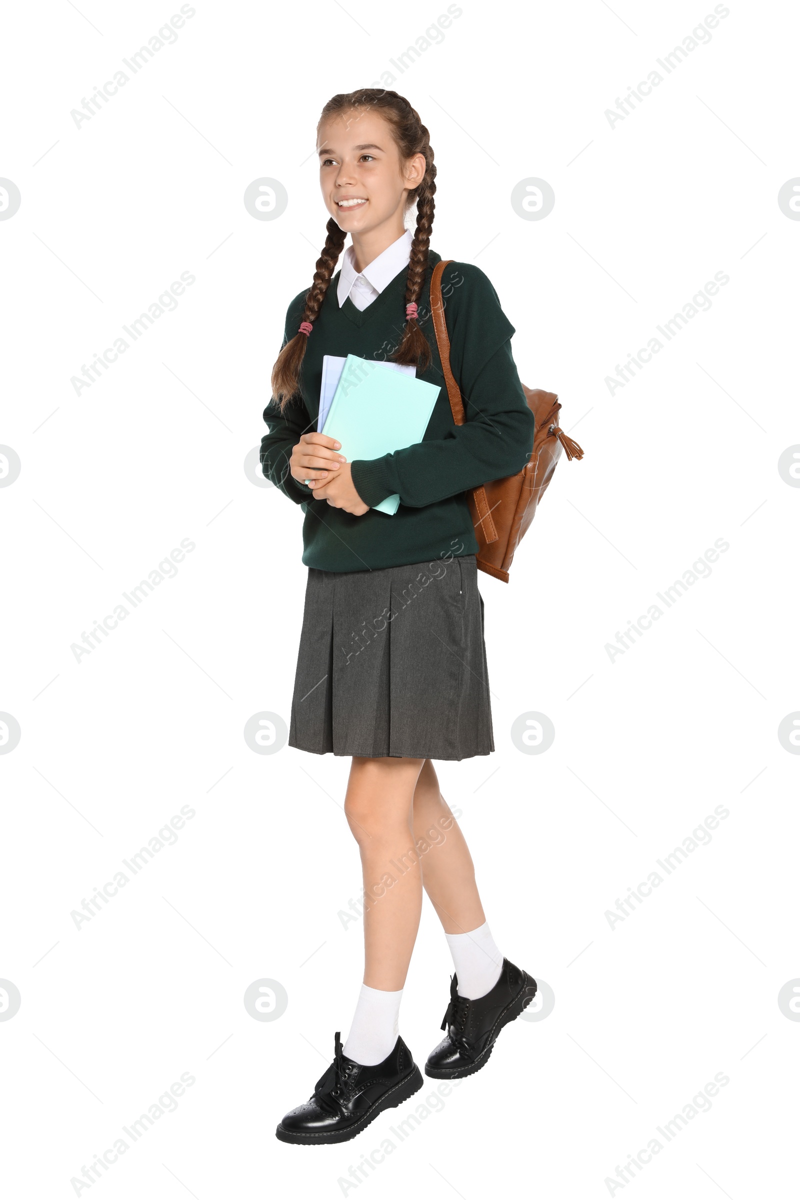 Photo of Teenage girl in stylish school uniform on white background