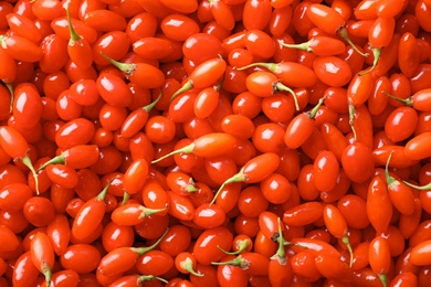 Photo of Fresh ripe goji berries as background, top view