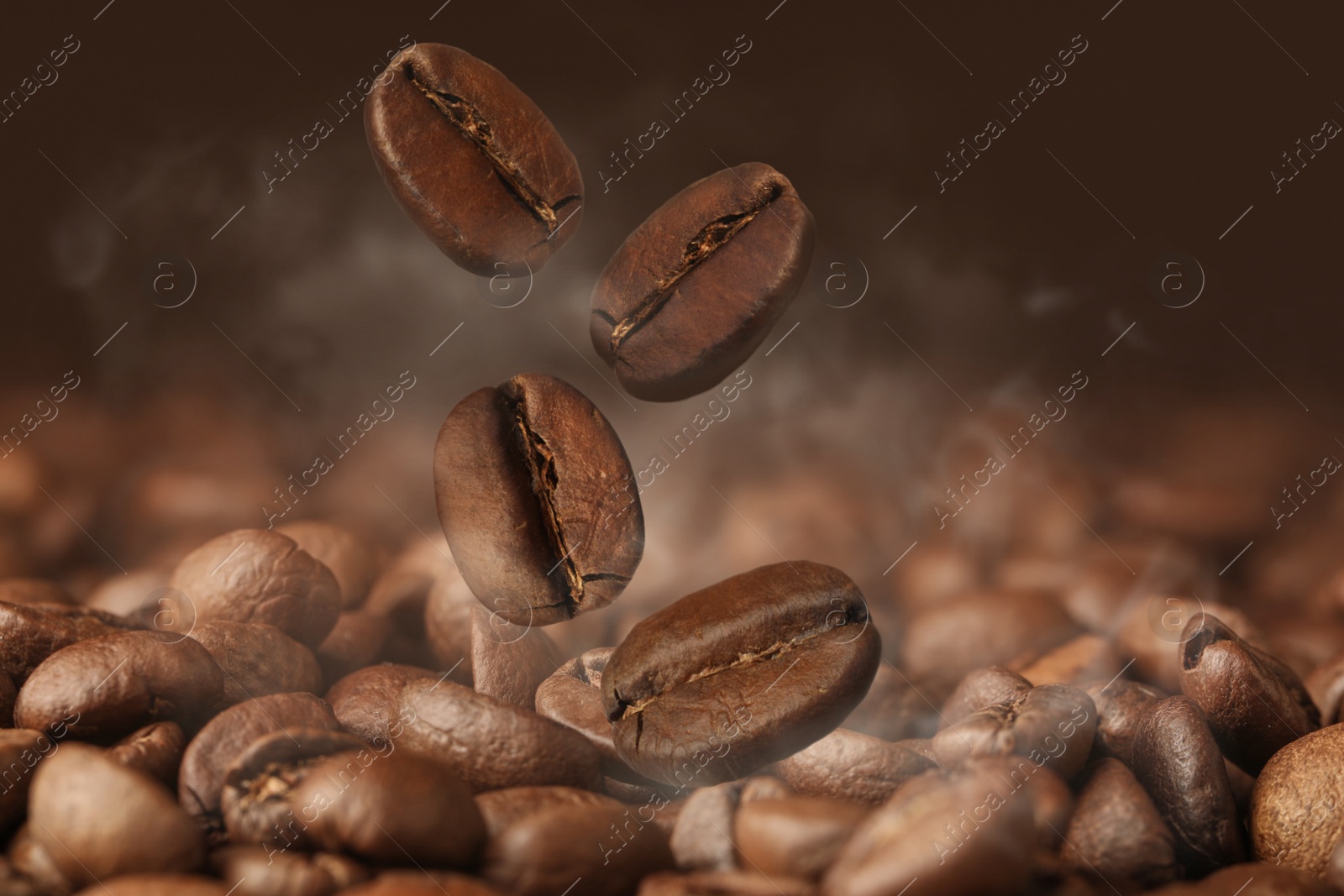 Image of Aromatic roasted coffee beans and steam, closeup