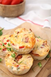 Photo of Delicious egg muffins with cheese and bacon on table, closeup. Space for text