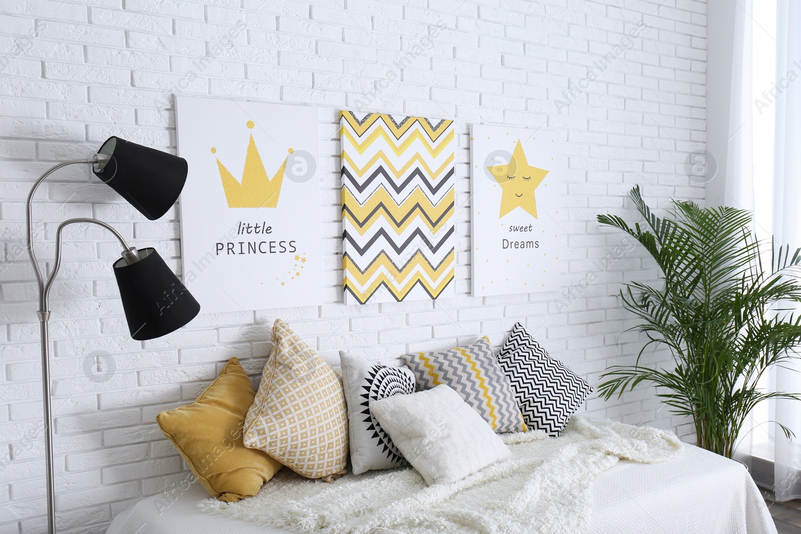 Photo of Child's room interior with bed and cute posters on wall