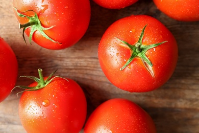 Photo of Fresh ripe tomatoes on wooden table, flat lay