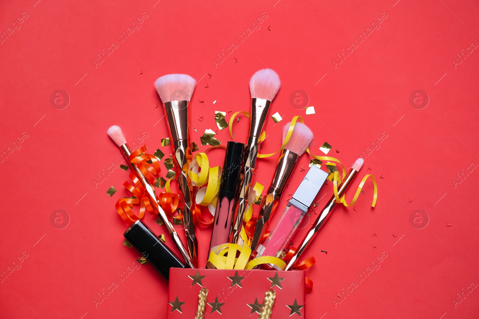 Photo of Flat lay composition with makeup products on red background