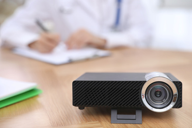 Photo of Video projector on table during medical conference