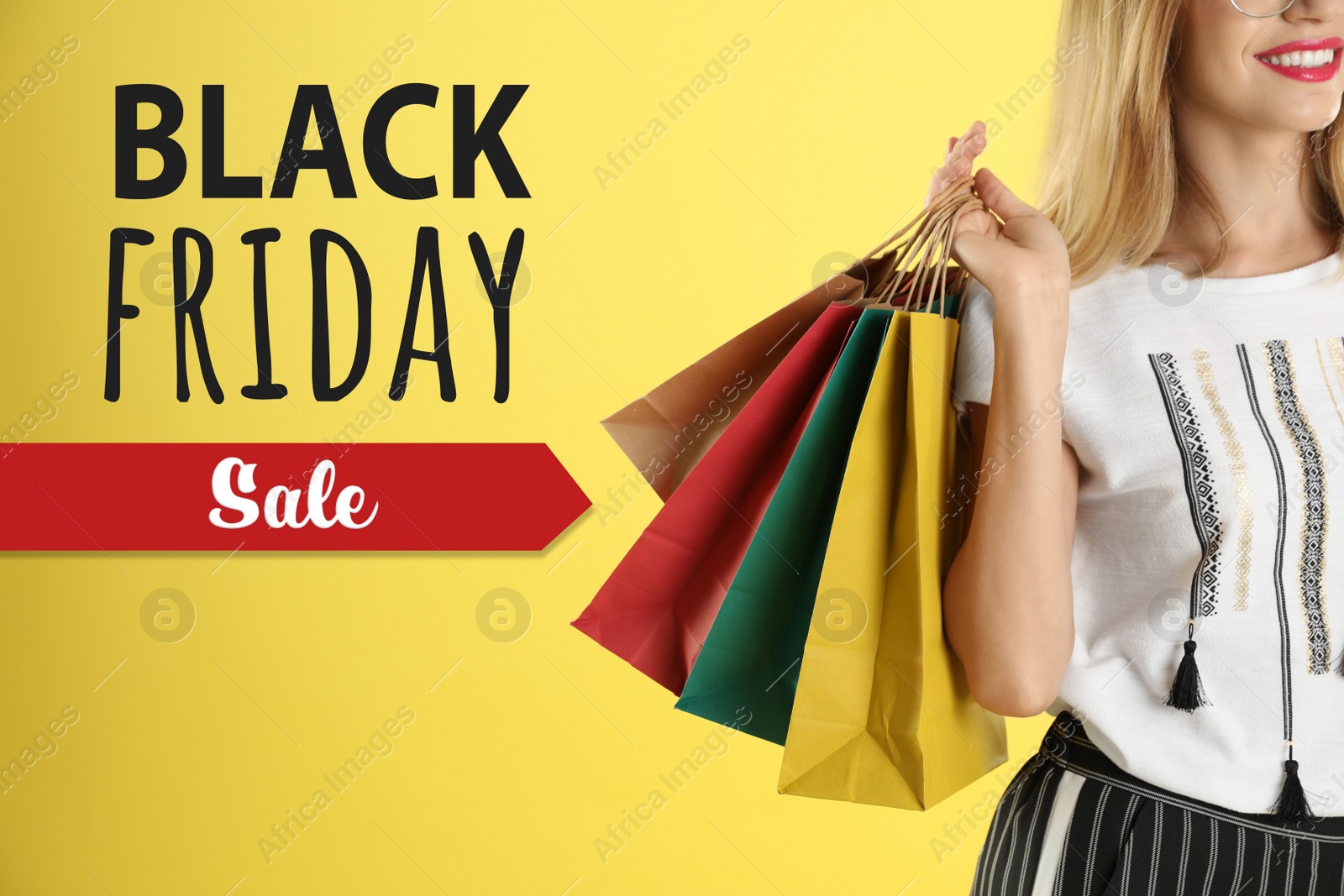 Image of Black Friday Sale. Young woman with shopping bags on yellow background, closeup 