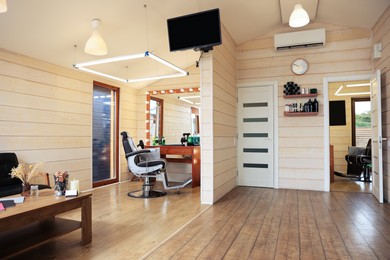 Photo of Stylish barbershop interior with professional hairdresser's workplace