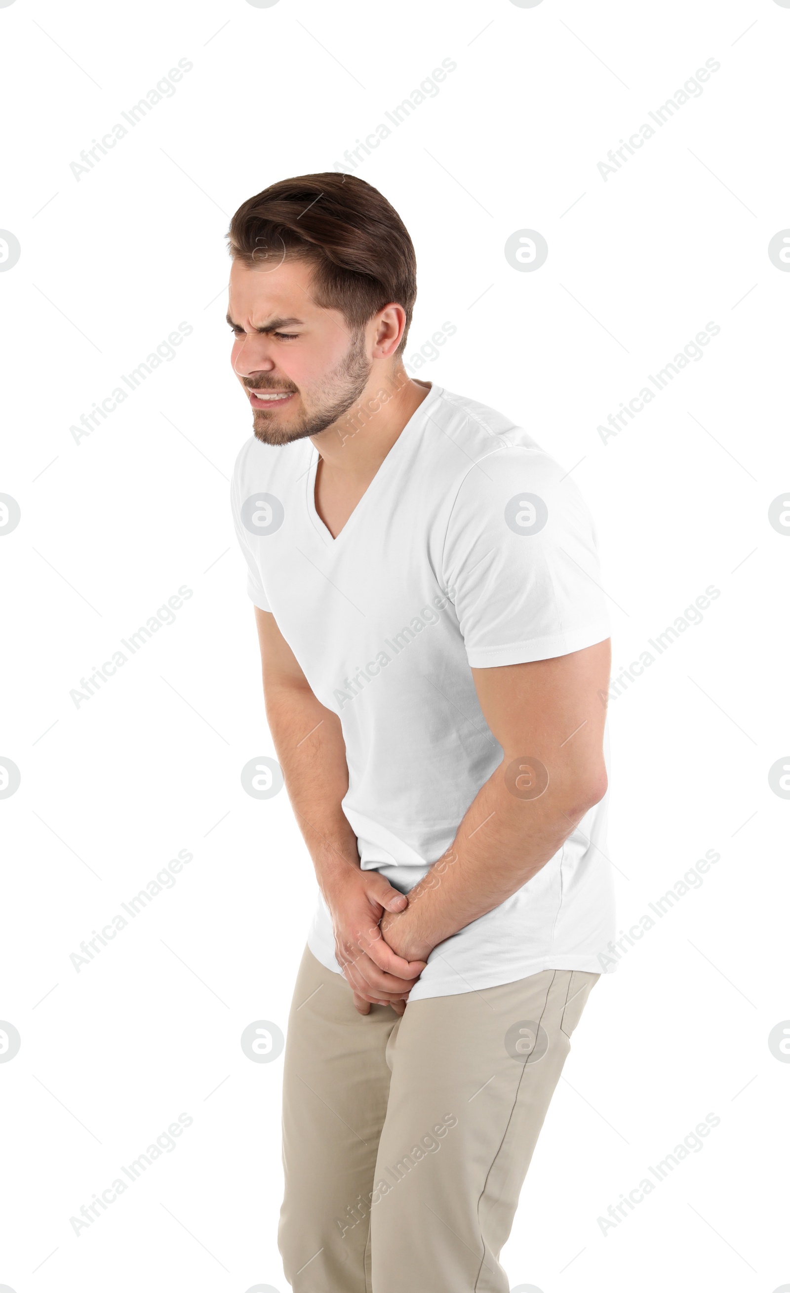 Photo of Young man with urological problems suffering from pain on white background