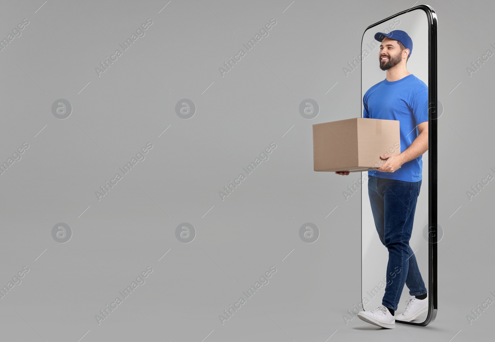 Image of Courier with parcel walking out from huge smartphone on grey background. Delivery service. Space for text