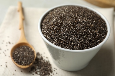 Chia seeds in bowl on table, closeup. Space for text